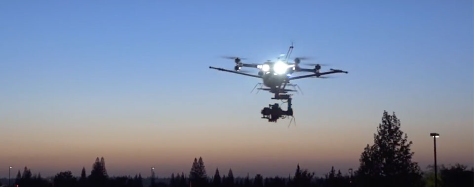 A drone hovers at dusk before flying into formation